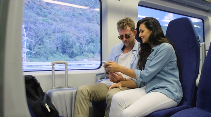 couple sitting on a train and talking 