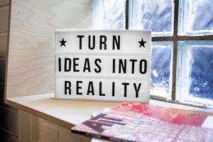 A sign saying 'turn ideas into reality'