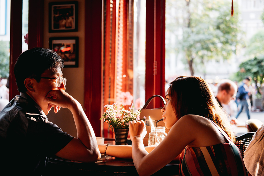 Man and woman sitting at a cafe table